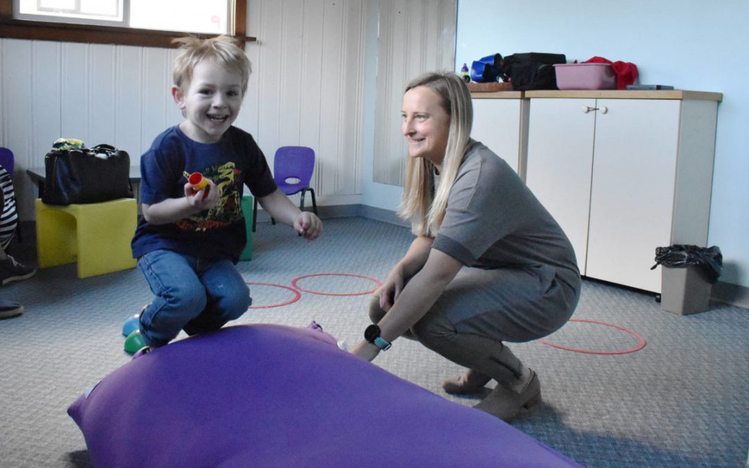 occupational therapist Carlin Christensen works with four-year-old Declan.